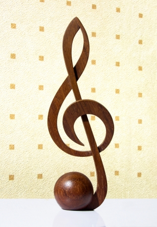 G-clef icon carved from wood on beige backgroudの写真素材