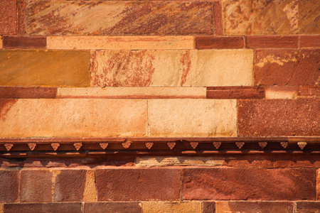 Stone wall texture background with flowers pattern in centralの写真素材