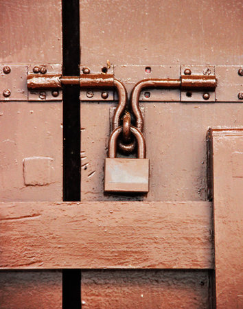 Brown padlock on brown hardwood door