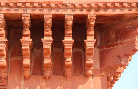 Front of carved stone colonnade at amber fort, india in sunny day
