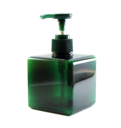 Green plastic bottle with dispenser pump on white backgroundの写真素材