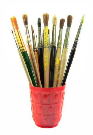Paint brushes set in the red cup on white backgroundの写真素材