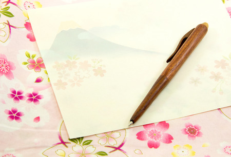 Fuji Mount pattern on letter paper and wood pen on sakura pattern clothの写真素材