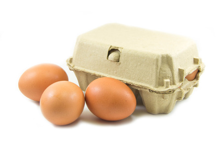 Eggs and paper egg tray on white backgroundの写真素材