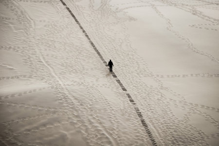 Silhouette of a man climbing at mingsha shan sand mountain, Zhangye, Chinaの写真素材
