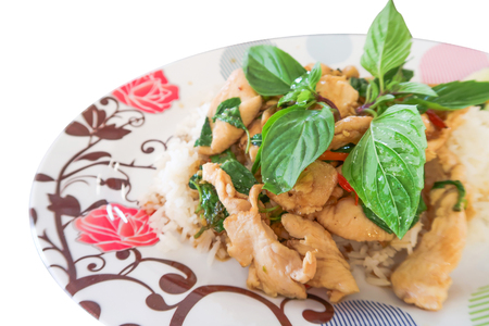 Basil fried rice with chicken, cucumber, basil on white backgroundの写真素材