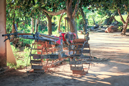Old red wheel plow in the gardenの写真素材