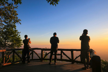 KANCHANABURI PROVINCE, THAILAND - MARCH 30, 2019: People take photos sunrise at viewpoint, Thong Pha Phum National Park, Kanchanaburi, Thailandのeditorial素材