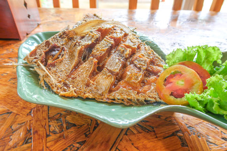 Fired fish with fish sauce  on board background