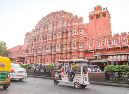Jaipur, Rajasthan, India - February 20 2020: Auto Rickshaw on the road at Hawa Mahal, the Palace of...
