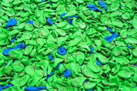 Blue and green balloon heap industry after the process in the factory backgroundの写真素材