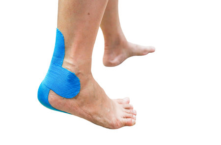 Blue  taping on pain women foot isolated on white backgroundの写真素材