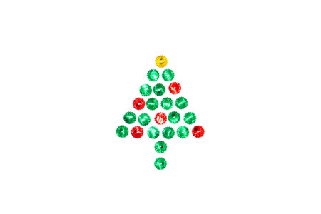 Christmas tree symbol made from red, green and gold glitter sparkles in the center on a white background. Flat lay, top view christmas, new year, winter creative concept.の写真素材