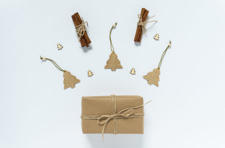 Flat lay composition with Christmas gifts and festive decor on white background. Holiday and...