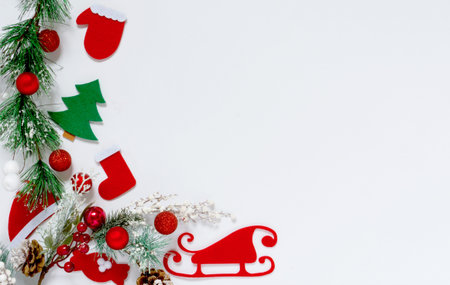 Christmas composition. New Years toys, fir branches and red berries on a white background. Flat lay,...