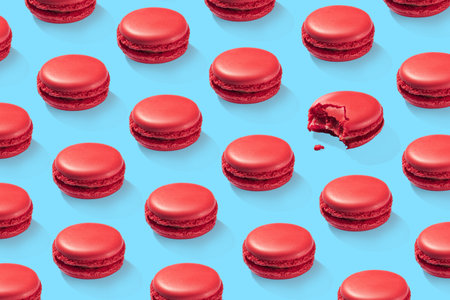 Strawberry macarons pattern on blue background isolatedの写真素材