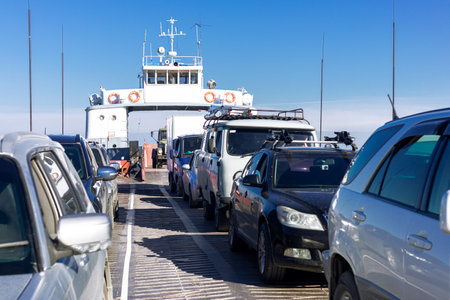 On the ferry with cars. Auto ferry carries cars and trucks on blue sea.の写真素材