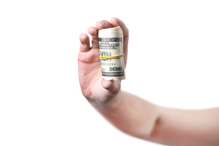 A hand shows a roll of money isolated on white background 100 dollars