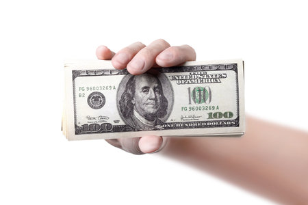 A hand shows a money isolated on white  background 100 dollars close up