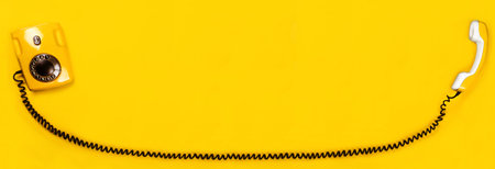 Yellow old stylish Phone, telephone with dial on yellow background copy space for your text banner...