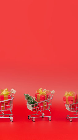 Supermarket trolley, with gifts, purchases and new year tree. Sale, Discounts, New Year, Christmas. Copy space verticalの写真素材