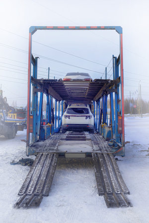 Car carrier. Loading cars on a car carrier. Transportation of cars anywhere in the country