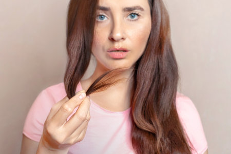 Woman shows her cropped hair. She doesn't like themの写真素材