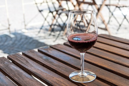 a glass of red wine on the table of street cafe,Tuscany, Italyの写真素材