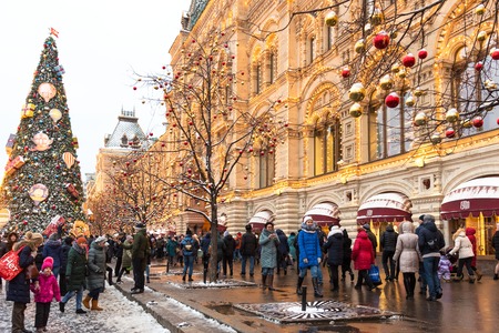 Moscow, Russia - January 5, 2018: New Year and Christmas market and decorations on Red Square. GUM with a tree and walking peopleのeditorial素材