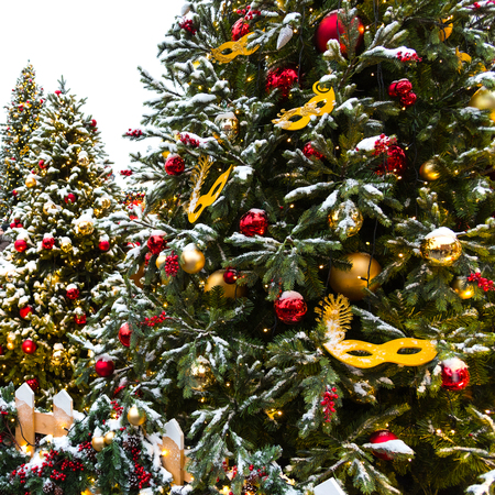 Moscow Festival Journey to Christmas . Illuminated New Year trees on Manezhnaya Square in front of Historical Museum. Golden carnival mask for decorating a Christmas tree.の写真素材