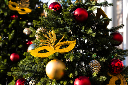 Moscow Festival Journey to Christmas . Illuminated New Year trees on Manezhnaya Square in front of Historical Museum. Golden carnival mask for decorating a Christmas tree.の写真素材