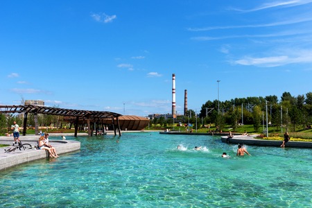 Moscow, Russia - 29 July 2018: Pond of Park Tiufielieva Roshcha ZILART - a new city park in the south of Moscow, located in the Danilov district of Moscow, Russia. People are swimming in the pond. Sunny weather and blue skyのeditorial素材