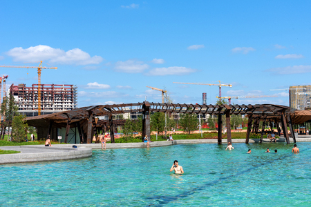 Moscow, Russia - 29 July 2018: Pond of Park Tiufielieva Roshcha ZILART - a new city park in the south of Moscow, located in the Danilov district of Moscow, Russia. People are swimming in the pond. Sunny weather and blue skyのeditorial素材