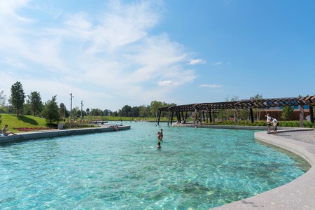 Moscow, Russia - 29 July 2018: Pond of Park Tiufielieva Roshcha ZILART - a new city park in the south of Moscow, located in the Danilov district of Moscow, Russia. People are swimming in the pond. Sunny weather and blue skyのeditorial素材