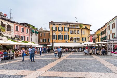 Sirmione, Italy - April 29, 2018: A view of the picturesque Piazza Carducci,the main square of Sirmione with restaurant and touristsのeditorial素材
