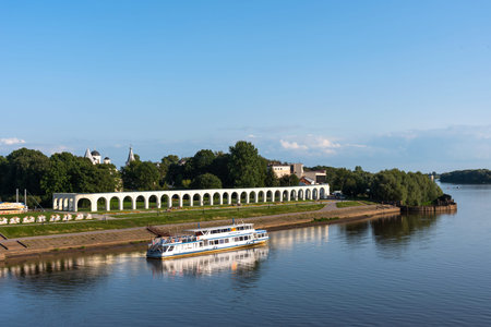 Veliky Novgorod, Russia - August 31, 2018: Panoramic view of the Yaroslav's Court in summer. Arcade Gostiny Dvor, Embankment and ships with tourists. Veliky Novgorod, Russiaのeditorial素材