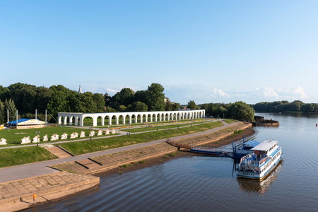 Veliky Novgorod, Russia - August 31, 2018: Panoramic view of the Yaroslav's Court in summer. Arcade Gostiny Dvor, Embankment and ships with tourists. Veliky Novgorod, Russiaのeditorial素材