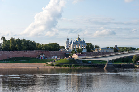Veliky Novgorod, Russia - August 31, 2018: Panoramic view of the Kremlin, Cathedral of St Sophia , The belfry of St. Sophia Cathedral, Nizhny Novgorod, Russia. The Volkhov River, the beach and the bridge over the riverのeditorial素材