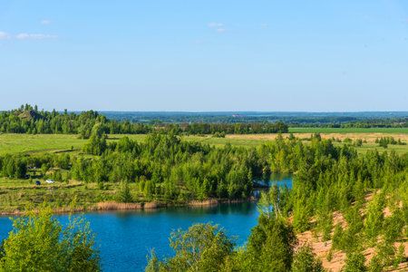Aerial view of picturesque hills and blue lakes in Konduki, Tula region, Russia. Turquoise quarry in...
