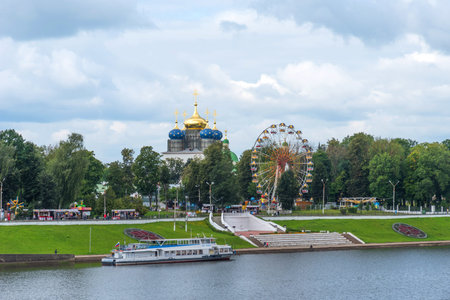 Tver, Russia - August 3, 2019: Summer panoramic view of the embankment of Volga river with a multi-colored ferris wheel, a pier for boats and Transfiguration Cathedralのeditorial素材