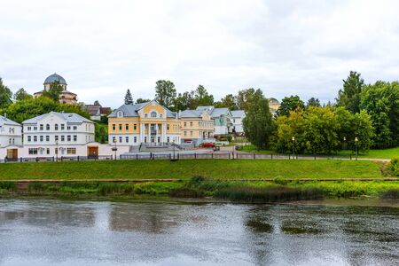 Torzhok, Russia - August 4, 2019: Panoramic summer view of the embankment of the Tvertsa river with old buildings in Torzhok, Russiaのeditorial素材