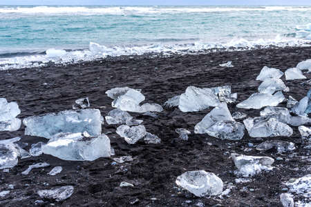 Picturesque winter landscape view of Diamond beach near Jokulsarlon lagoon, Iceland. Amazing picturesque view of black sand beach with iceberg pieces on Diamond beach near Jokulsarlon lagoon in winterの写真素材