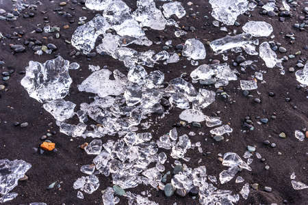 Picturesque winter landscape view of Diamond beach near Jokulsarlon lagoon, Iceland. Amazing picturesque view of black sand beach with iceberg pieces on Diamond beach near Jokulsarlon lagoon in winterの写真素材