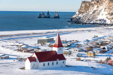 Picturesque aerial view of Vik I Myrdal church on the top of hill in Iceland. Aereal winter landscape view of Vik I Myrdal with in Iceland.の写真素材