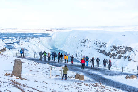 GULLFOSS, ICELAND - March 4, 2020: People at viewpoint over Gullfoss waterfall, one of the most popular tourist attractions in Iceland.のeditorial素材