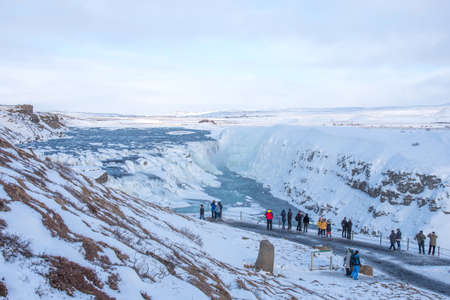GULLFOSS, ICELAND - March 4, 2020: People at viewpoint over Gullfoss waterfall, one of the most popular tourist attractions in Iceland.のeditorial素材