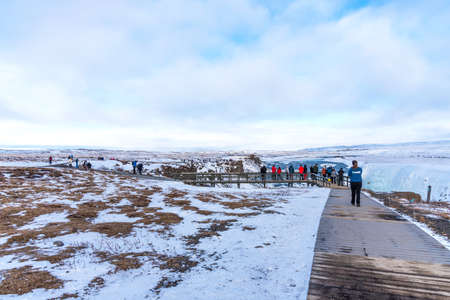 GULLFOSS, ICELAND - March 4, 2020: People at viewpoint over Gullfoss waterfall, one of the most popular tourist attractions in Iceland.のeditorial素材