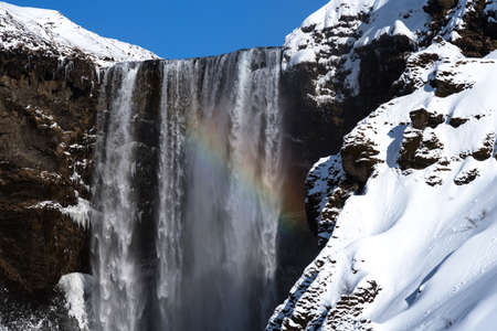 Amazing aerial winter landscape view of Skogafoss in Iceland. Skogafoss one of the biggest waterfalls and most popular tourist attractions in Iceland.の写真素材
