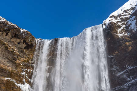 Amazing aerial winter landscape view of Skogafoss in Iceland. Skogafoss one of the biggest waterfalls and most popular tourist attractions in Iceland.の写真素材