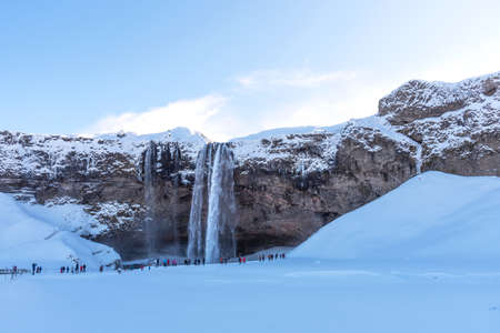 Picturesque winter landscape view of frozen beautiful waterfall Seljalandsfoss in Iceland. Aereal winter landscape view of waterfall Seljalandsfoss in Iceland.の写真素材